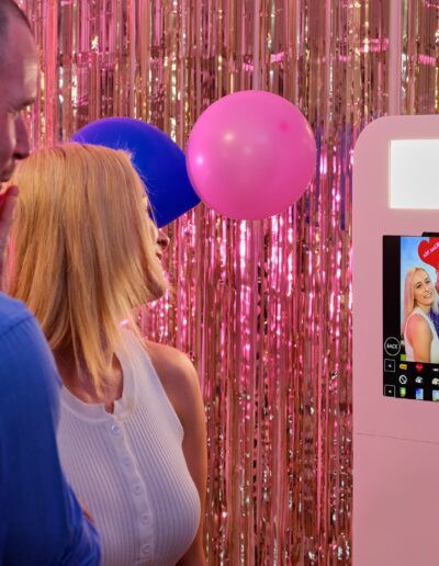 Ashley Photo Booth in action, couple taking cute picture with the leaning tower of pisa and love hearts in the background